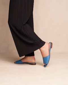 Model wearing Oya Layla blue slide low heel perfect summer shoe for plus or extended sizes.