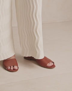 Short video of model wearing cream trousers and Nappa leather summer slide in coco, low heel women's shoe for extended or plus sizes.